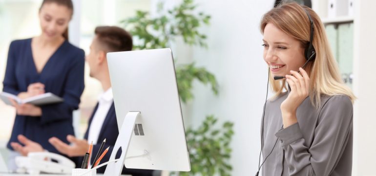 Female receptionist answering call with headset