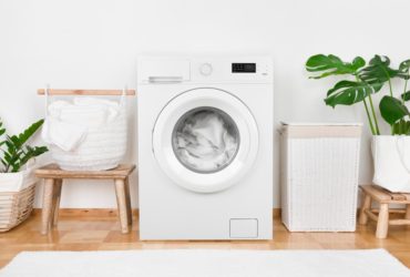 Laundry room with white washing machine and accessories
